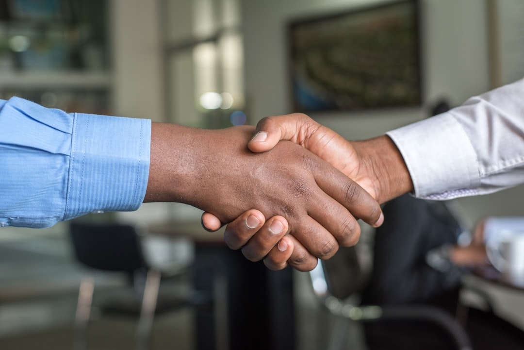 Two people shaking hands after a grant funding meeting