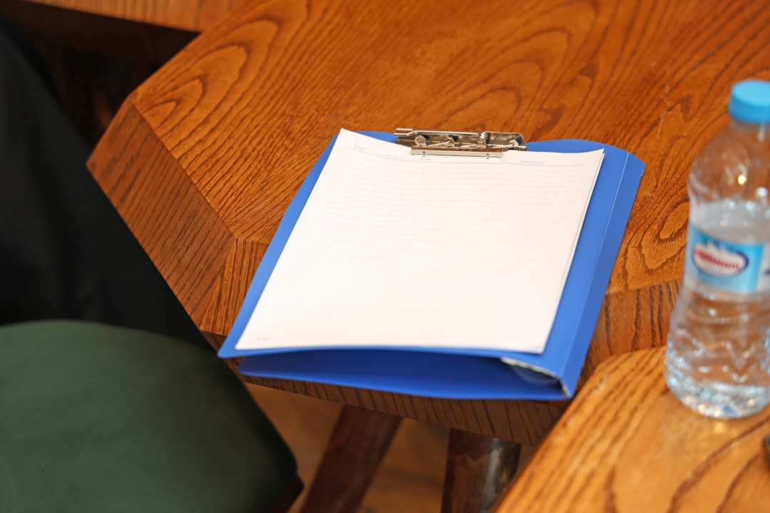 Clipboard with paperwork on a table, representing booster club nonprofit filing basics