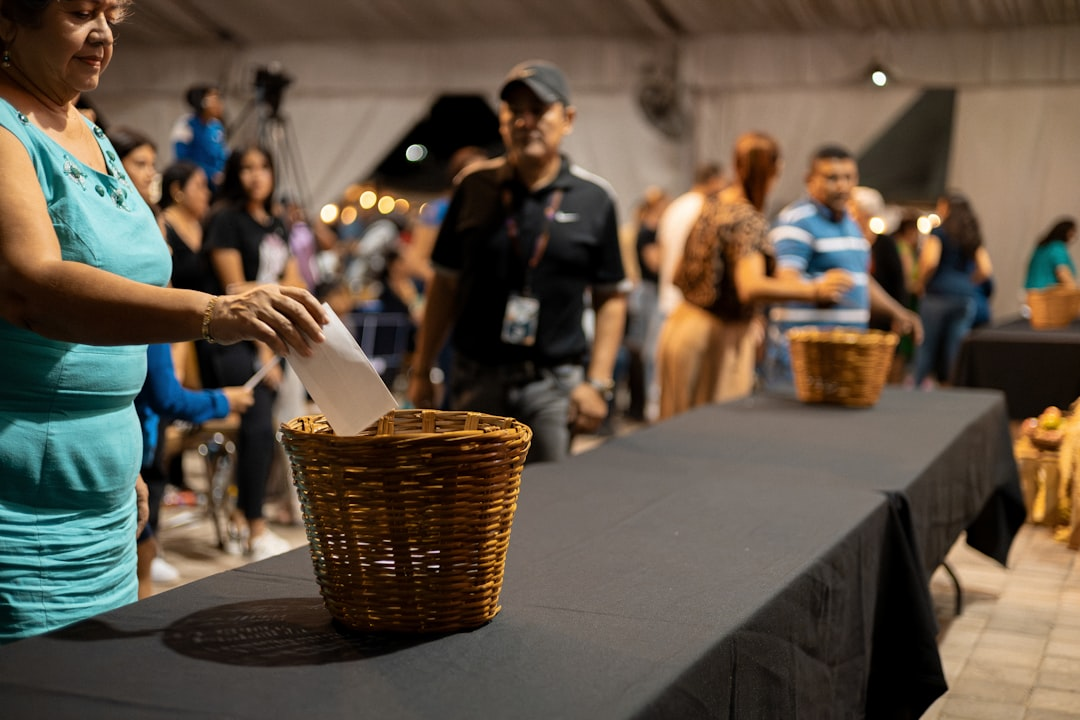 Guests browsing a table of donated silent auction items at a youth sports fundraiser