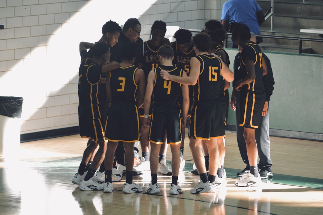 Youth sports team huddled together in new uniforms funded by a capital fundraising campaign
